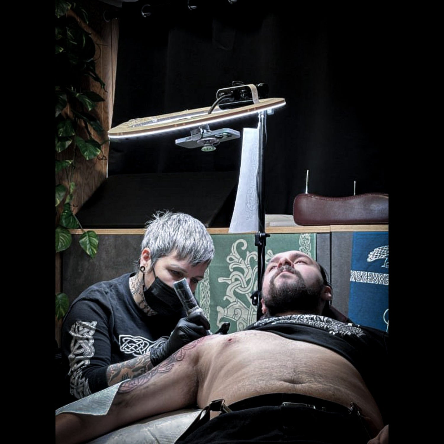 Hélène Morrigan working on a Viking and Norse mythology tattoo in her private studio in France
