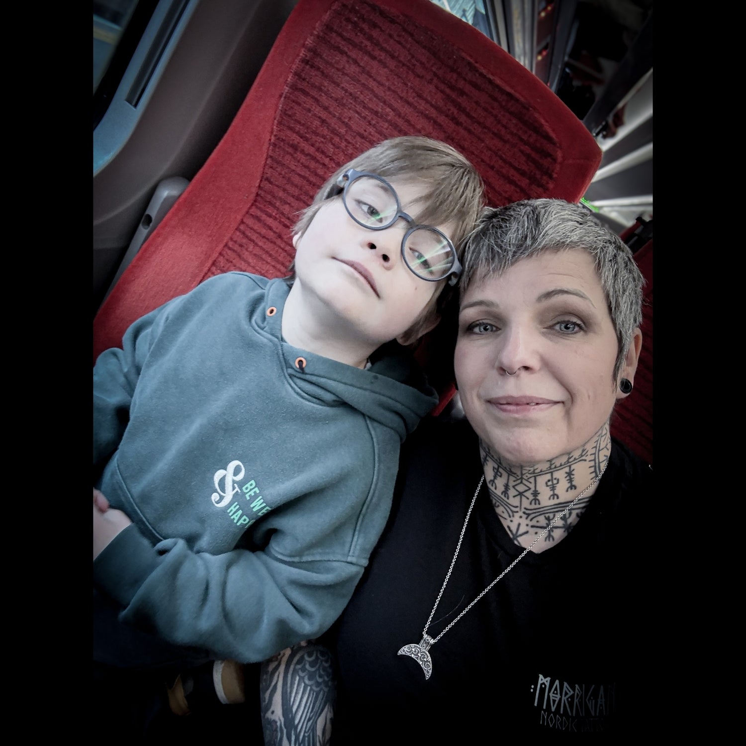 Hélène Morrigan with her son during a personal moment outside the tattoo studio