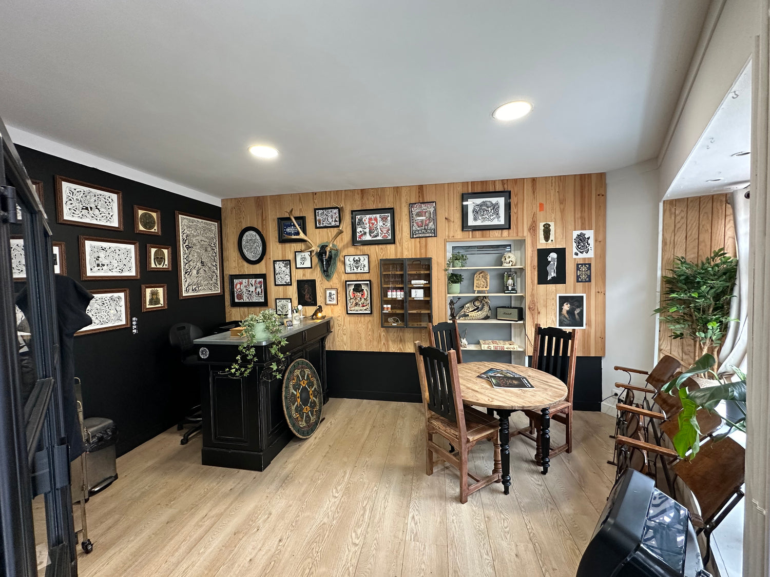 Entrance of Morrigan Tattoo studio in France featuring Nordic artwork, Viking-inspired shield and welcoming reception area