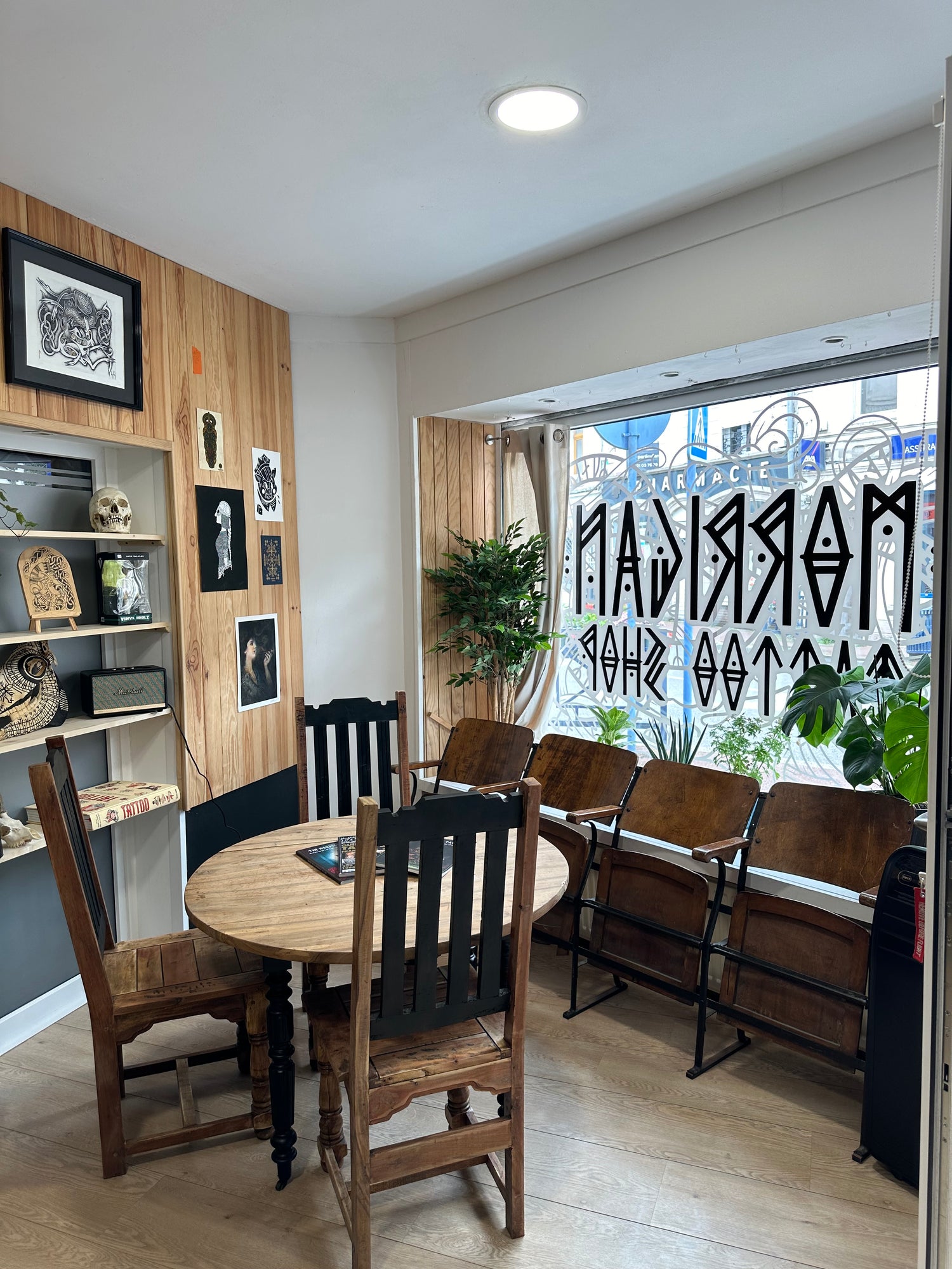 Interior of Morrigan Tattoo studio showing reception table and display window in a Nordic-inspired setting