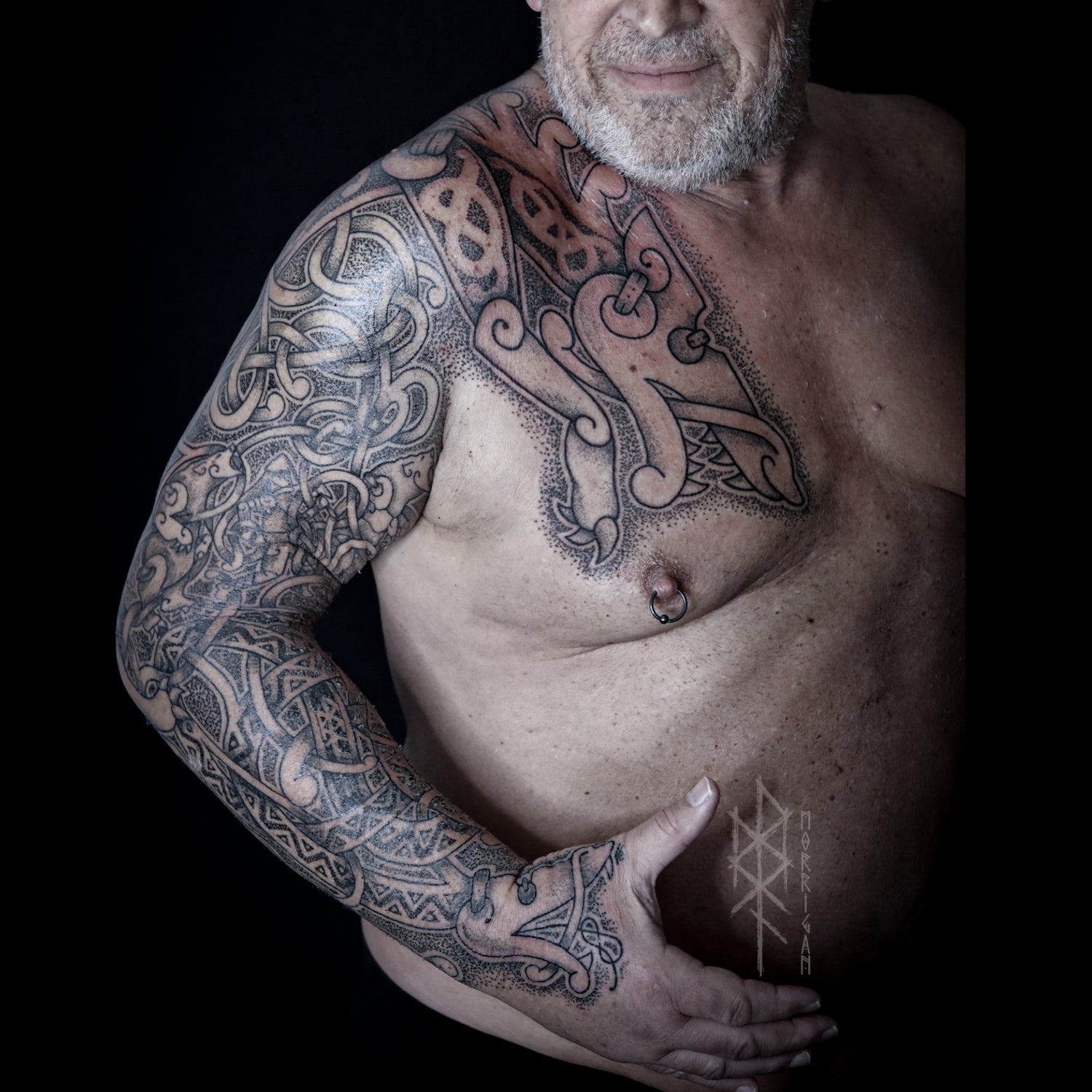 Norse mythology sleeve and chest tattoo featuring Fenrir, Jormungandr and bears in historical knotwork with detailed blackwork composition