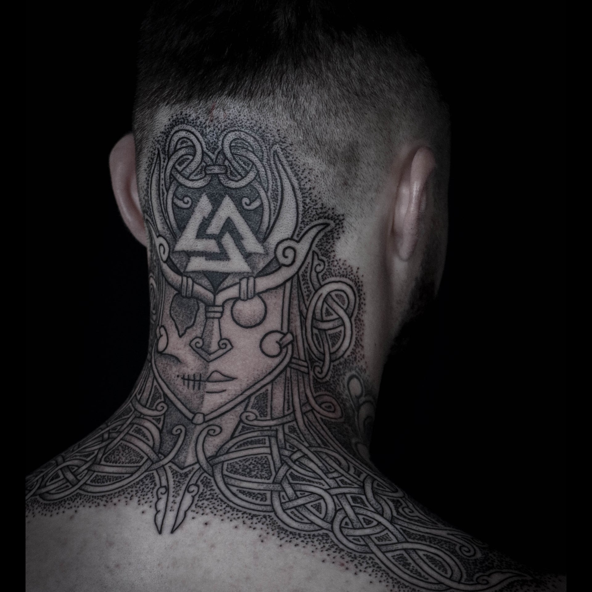 Norse back head and shoulders tattoo featuring a Hel godmask with Valknut and intricate knotwork design